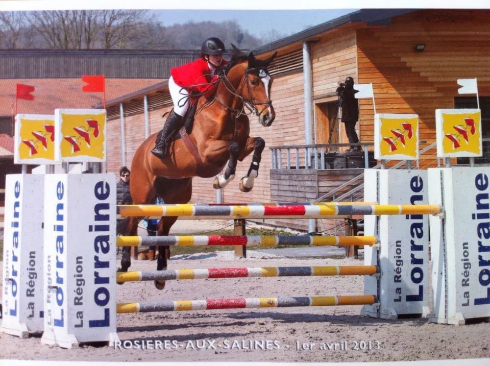 Rider clearing a show jump at L'Écurie Equestrian Club in Southwest Ranches, Florida.